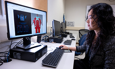 A female student creates a fashion design on a computer