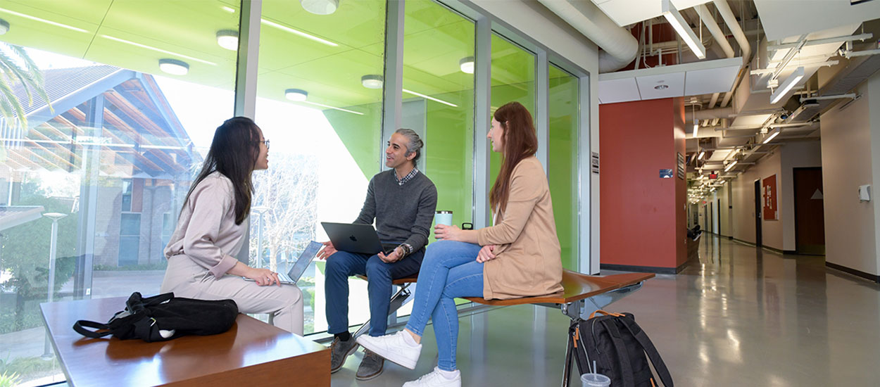 Professor discussing with two students