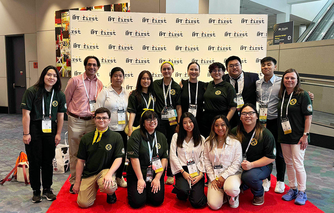 Food science students and advisors pose on the red carpet