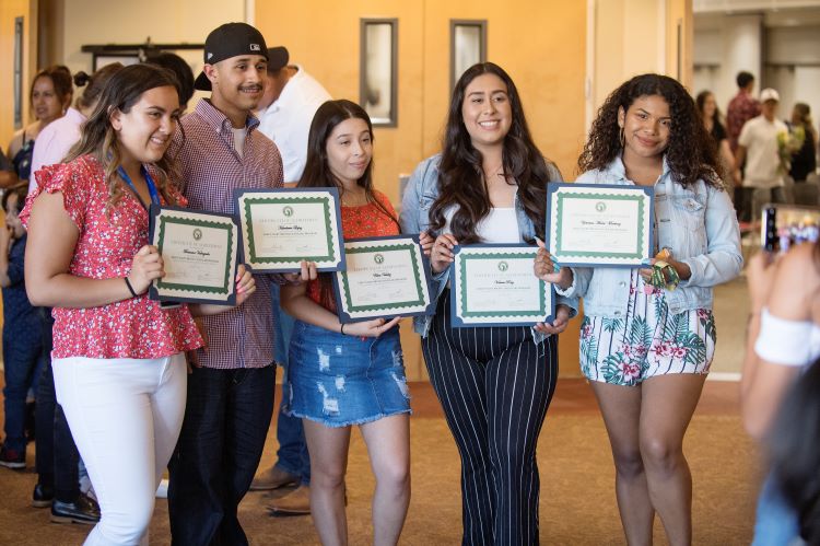 Group of 4 Bronco Scholars students pose with certificates