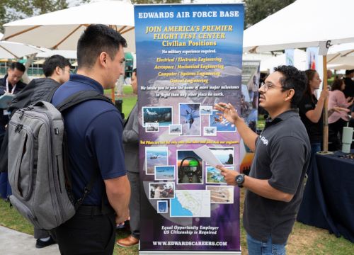 A recruiter talks to a student at a career fair